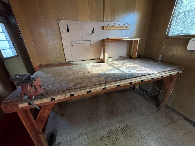 miscellaneous room featuring wood walls