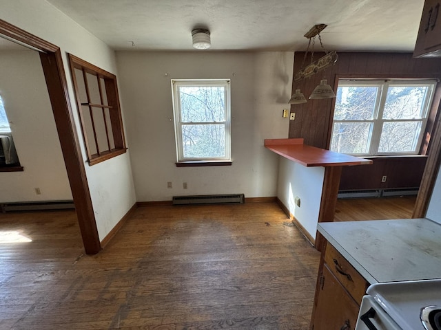 kitchen featuring baseboard heating, decorative light fixtures, and dark hardwood / wood-style flooring