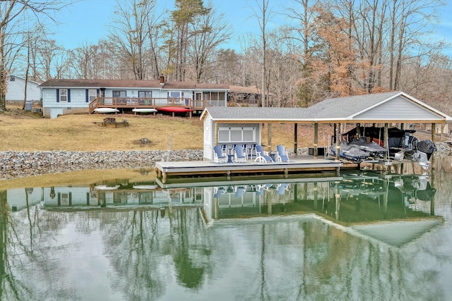 dock area featuring a deck with water view and a lawn