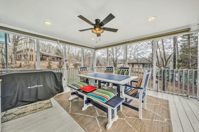 sunroom featuring ceiling fan