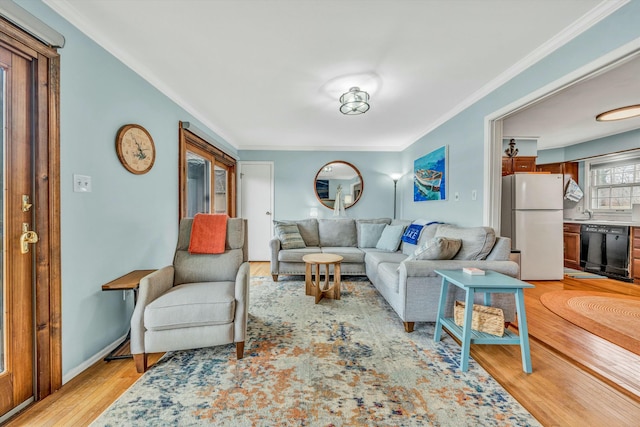 living room featuring crown molding and light wood-type flooring