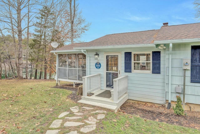 view of front of property with a sunroom and a front yard