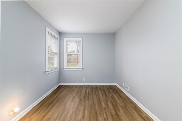 empty room with hardwood / wood-style floors