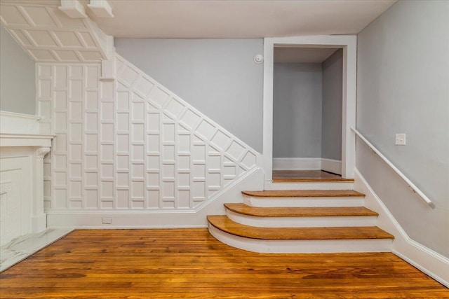 stairs featuring hardwood / wood-style floors