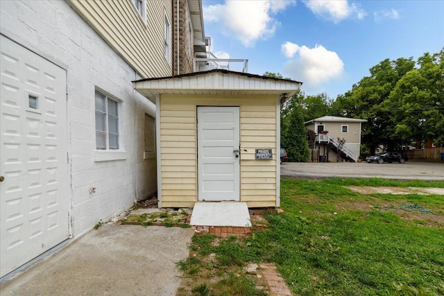 view of exterior entry featuring a yard