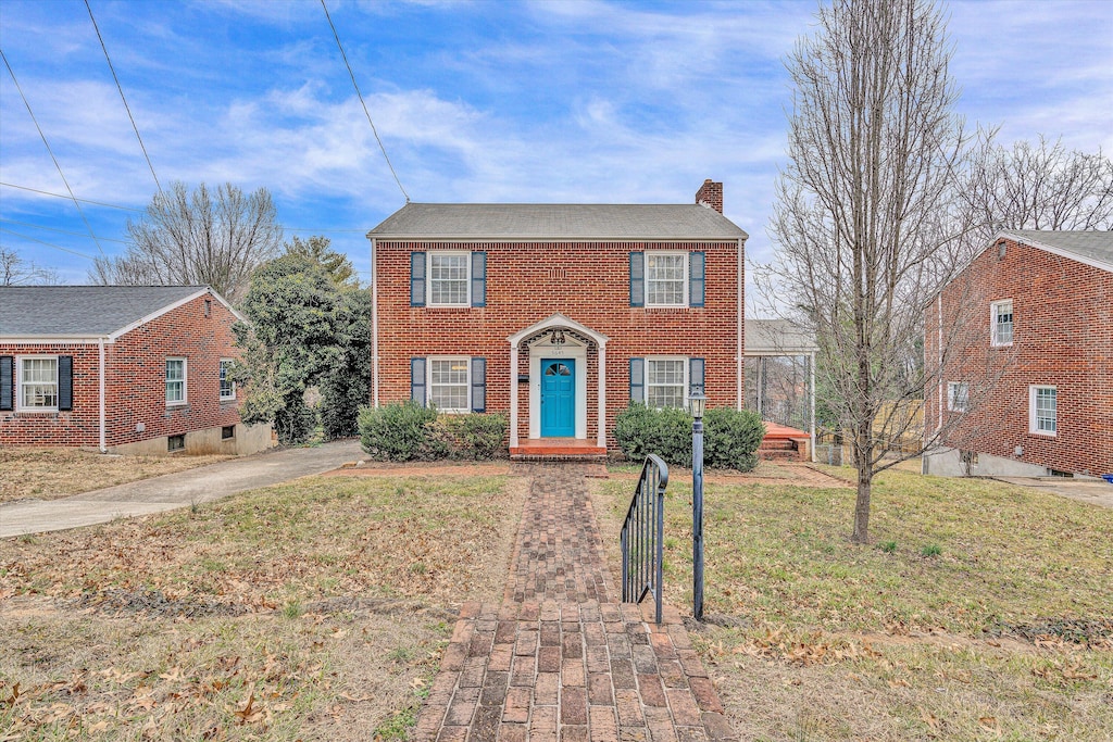 colonial-style house with a front lawn