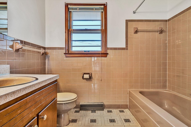 full bathroom with vanity, tiled shower / bath combo, tile walls, and toilet