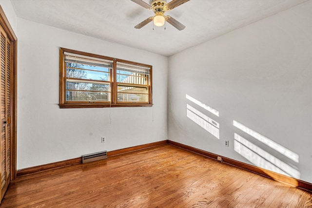 unfurnished bedroom with hardwood / wood-style floors, ceiling fan, and a closet