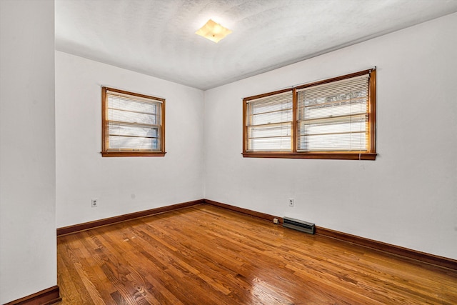 unfurnished room featuring wood-type flooring and a wealth of natural light