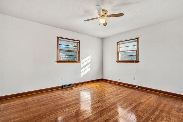 unfurnished room with hardwood / wood-style flooring, plenty of natural light, and ceiling fan