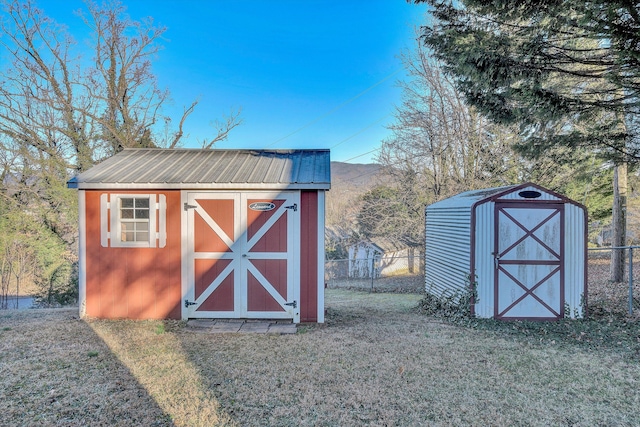 view of outbuilding featuring a lawn