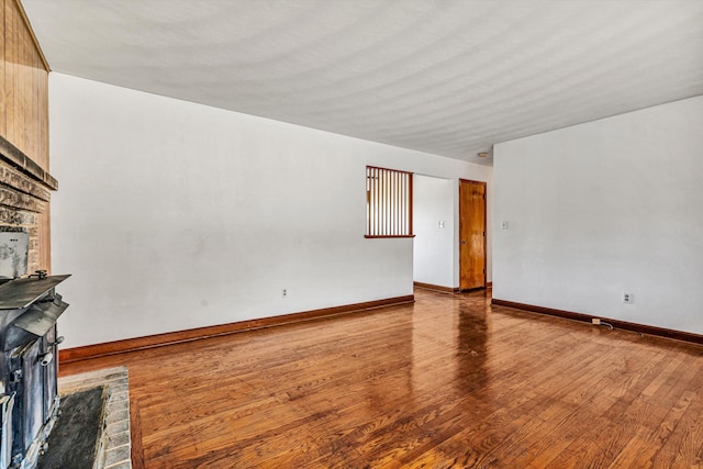 unfurnished living room featuring a fireplace and light wood-type flooring