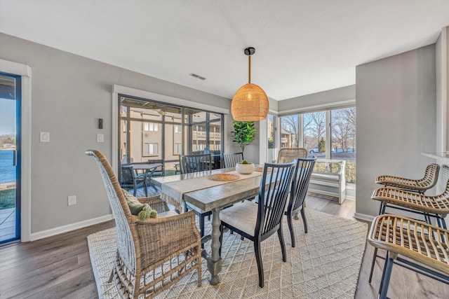 dining space with hardwood / wood-style floors