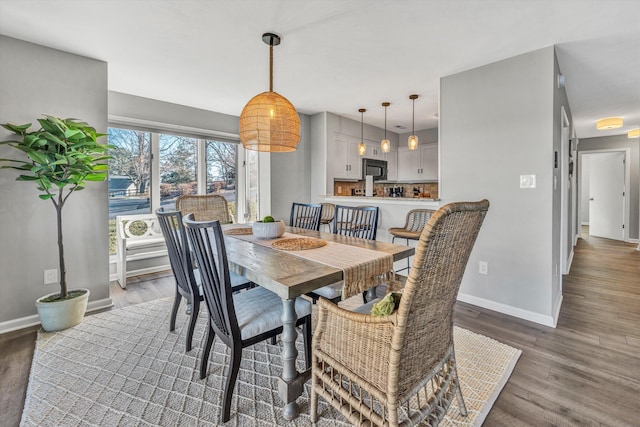 dining space with wood-type flooring