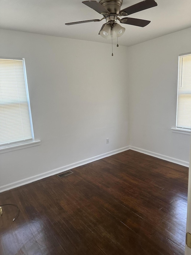 unfurnished room featuring dark hardwood / wood-style floors and ceiling fan