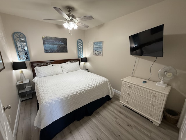 bedroom featuring ceiling fan, wood finished floors, and baseboards