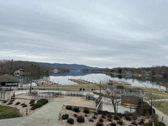 view of water feature featuring fence and a mountain view