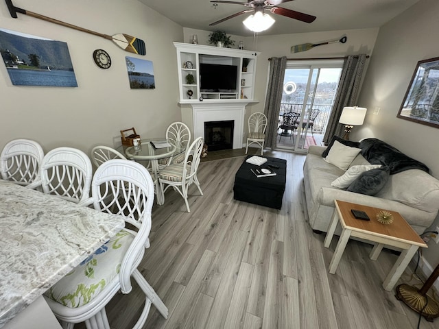 living room with hardwood / wood-style flooring and ceiling fan