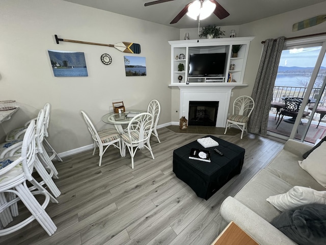 living room with hardwood / wood-style flooring and ceiling fan