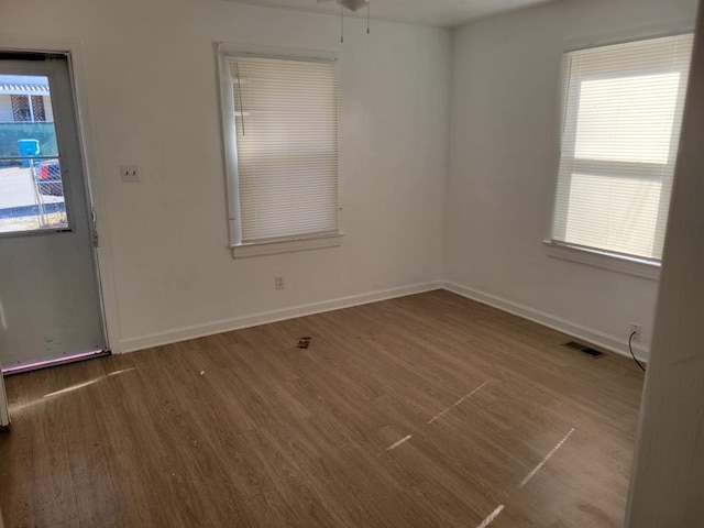 spare room featuring wood-type flooring