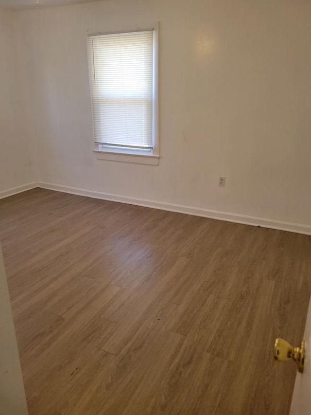 unfurnished room featuring dark hardwood / wood-style flooring