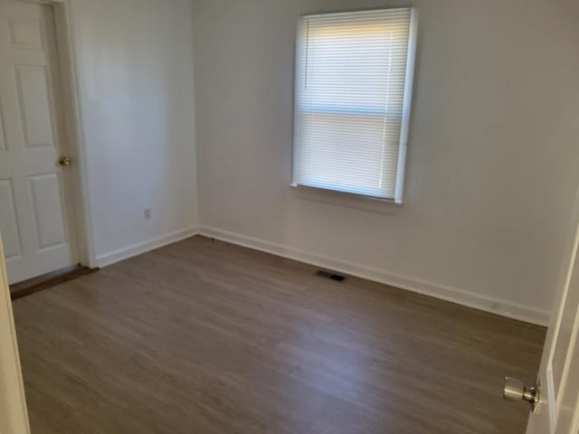 spare room featuring dark hardwood / wood-style floors