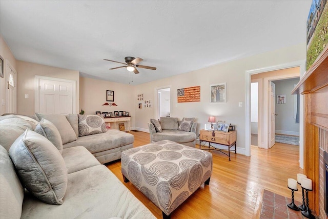 living room featuring ceiling fan and light wood-type flooring