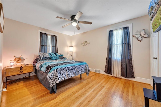 bedroom with ceiling fan and light wood-type flooring