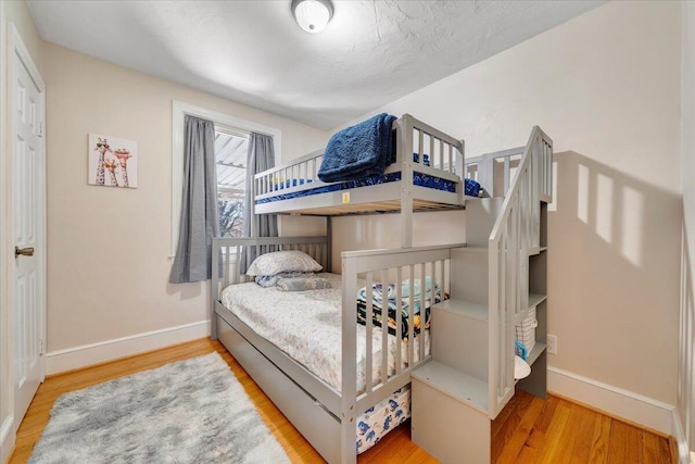 bedroom with hardwood / wood-style flooring