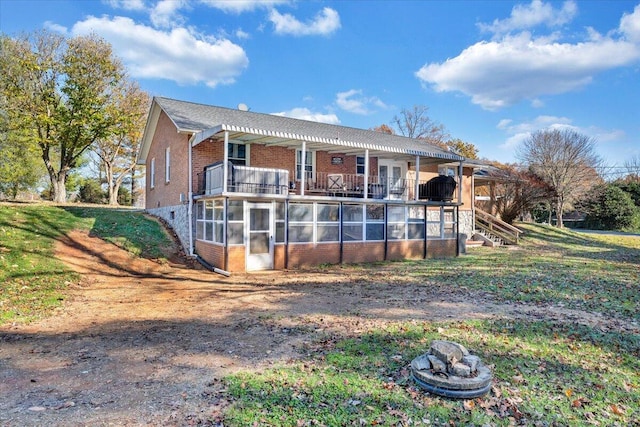 rear view of property with a sunroom