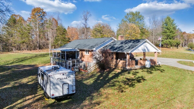 view of front of property with a carport and a front yard