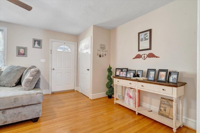 foyer entrance with hardwood / wood-style flooring and ceiling fan