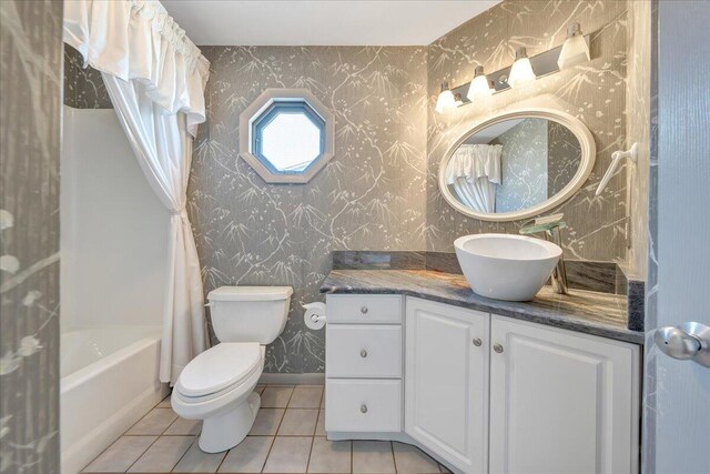 full bathroom with tile patterned flooring, vanity, shower / bath combination with curtain, and toilet