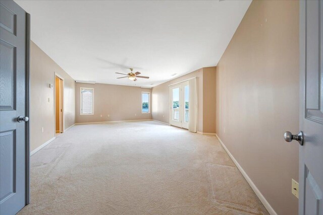 carpeted empty room with ceiling fan