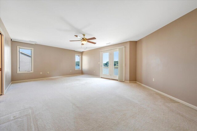 carpeted empty room featuring ceiling fan