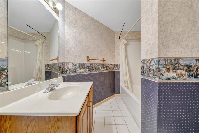 bathroom featuring tile patterned flooring, vanity, and shower / bathtub combination with curtain