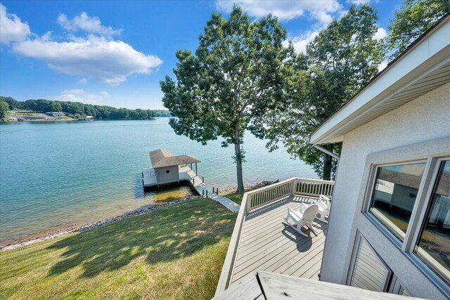 dock area with a yard and a water view