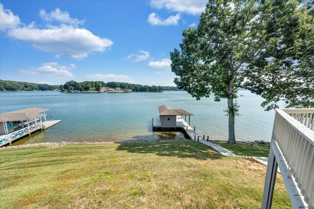 dock area featuring a water view and a yard