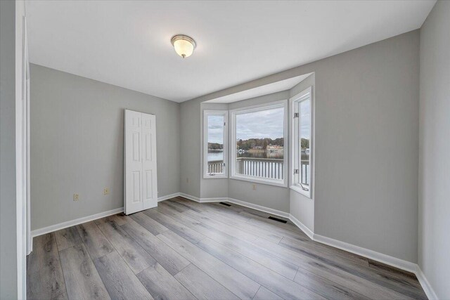 spare room with light hardwood / wood-style floors