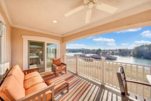 balcony with a water view and ceiling fan