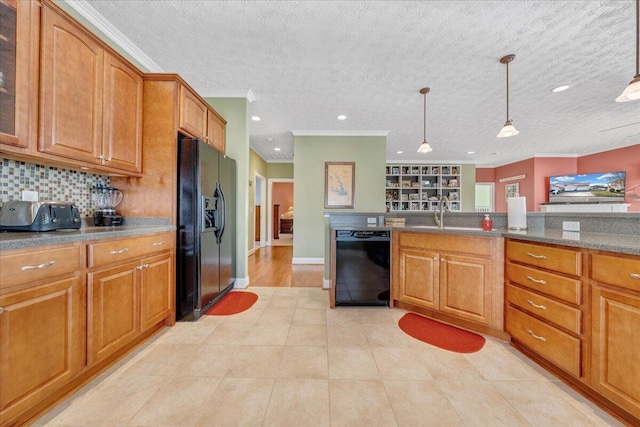 kitchen with sink, decorative light fixtures, ornamental molding, decorative backsplash, and black appliances