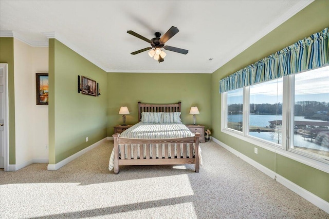 bedroom featuring a water view, ceiling fan, ornamental molding, and carpet flooring