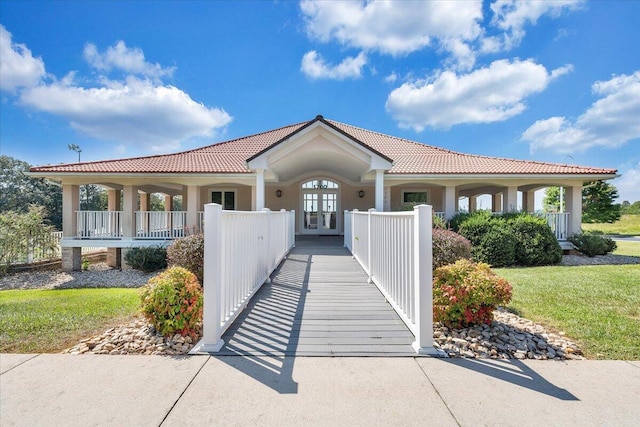 mediterranean / spanish-style home featuring french doors and a porch