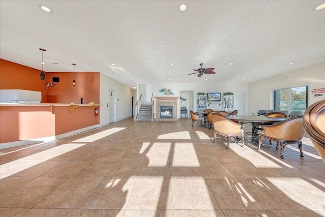 interior space featuring ceiling fan and a textured ceiling