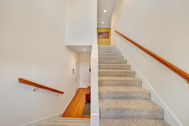 stairs with hardwood / wood-style floors