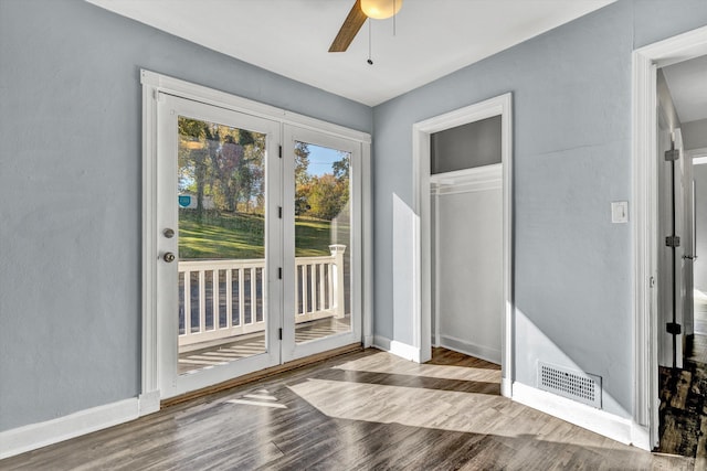 doorway featuring ceiling fan and light hardwood / wood-style flooring