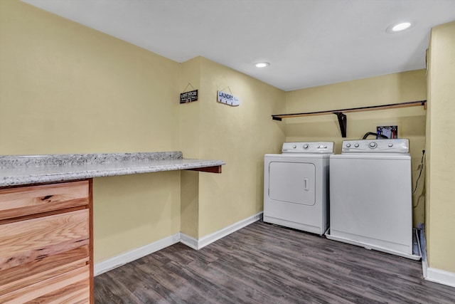 washroom featuring dark wood-type flooring and washer and clothes dryer