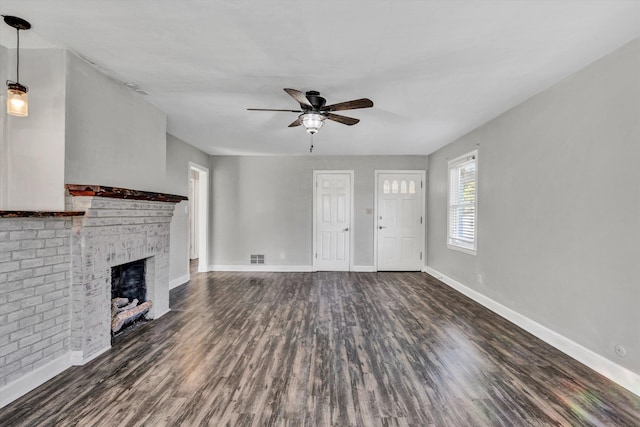 unfurnished living room with dark hardwood / wood-style flooring, a fireplace, and ceiling fan