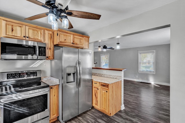 kitchen with dark hardwood / wood-style floors, kitchen peninsula, ceiling fan, stainless steel appliances, and light stone countertops