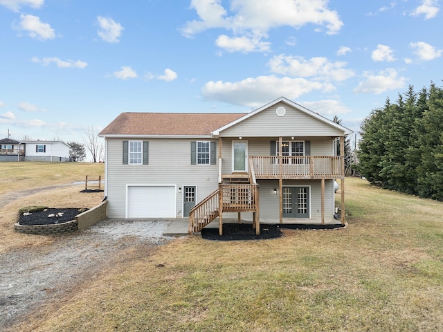 back of house featuring a garage, a wooden deck, and a lawn